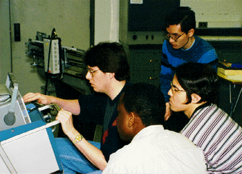 a photo of Mr. Mason helping student in lab